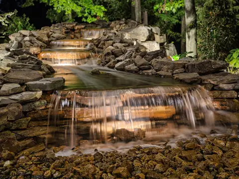 Stacked stone waterfall with underwater lights at each fall